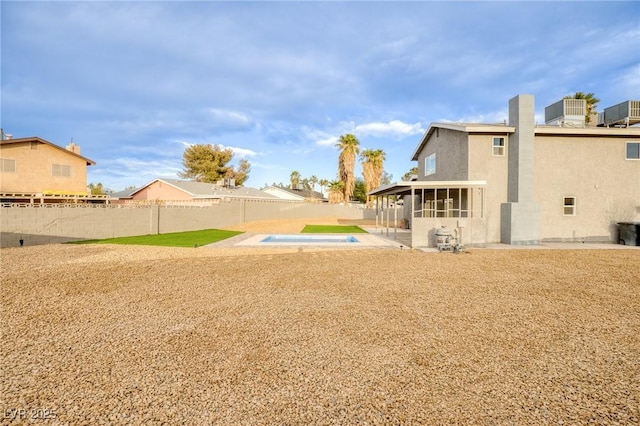 view of yard featuring a fenced in pool, a patio area, and a sunroom