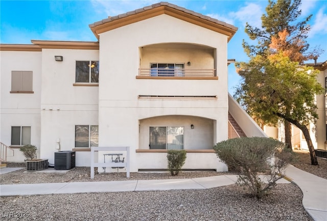 view of front of property featuring central AC and a balcony