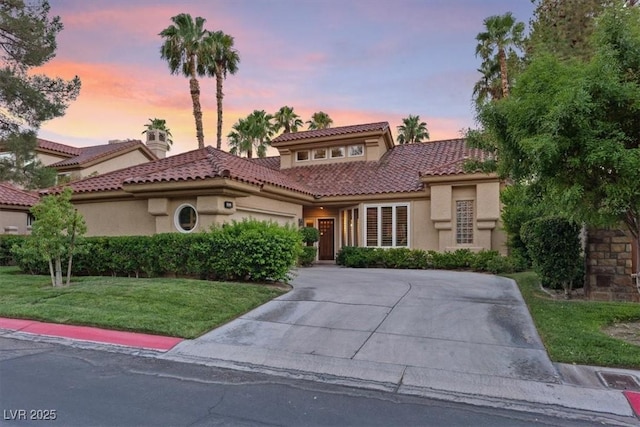 mediterranean / spanish-style house with a lawn