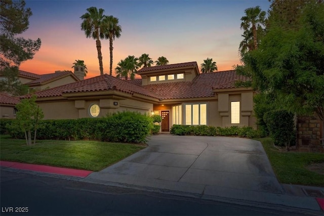 mediterranean / spanish-style house featuring a lawn