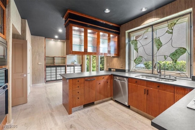 kitchen featuring sink, kitchen peninsula, a wealth of natural light, and dishwasher