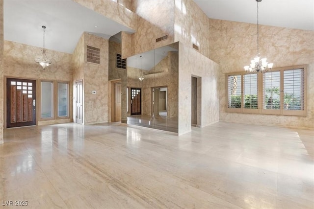 unfurnished living room with elevator and a notable chandelier