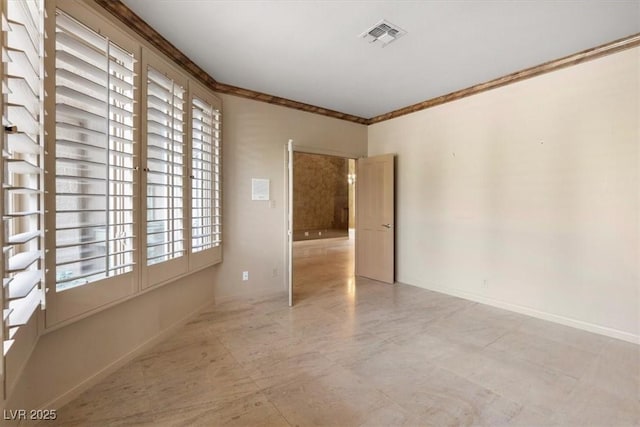 empty room featuring crown molding