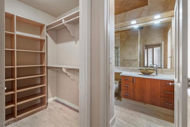 spacious closet featuring sink