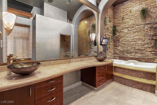 bathroom featuring vanity and a washtub