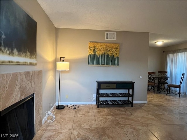 living room with a tile fireplace