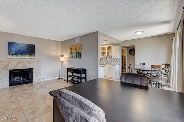 living room with a fireplace and a textured ceiling