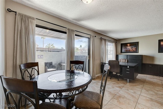 dining space featuring a textured ceiling and light tile patterned flooring