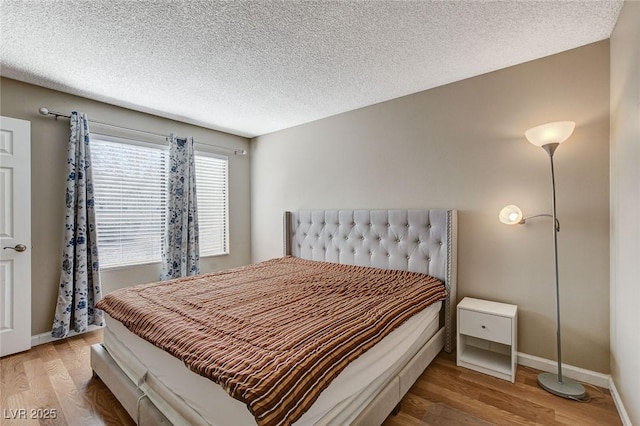 bedroom featuring hardwood / wood-style floors and a textured ceiling