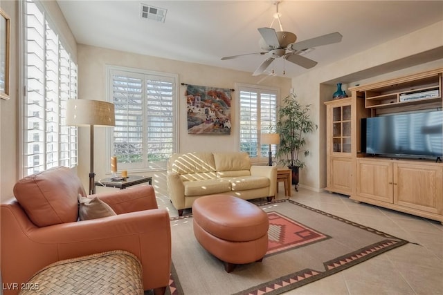 living room featuring light tile patterned floors and ceiling fan