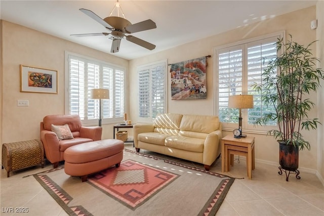 sitting room featuring light tile patterned floors, a wealth of natural light, and ceiling fan