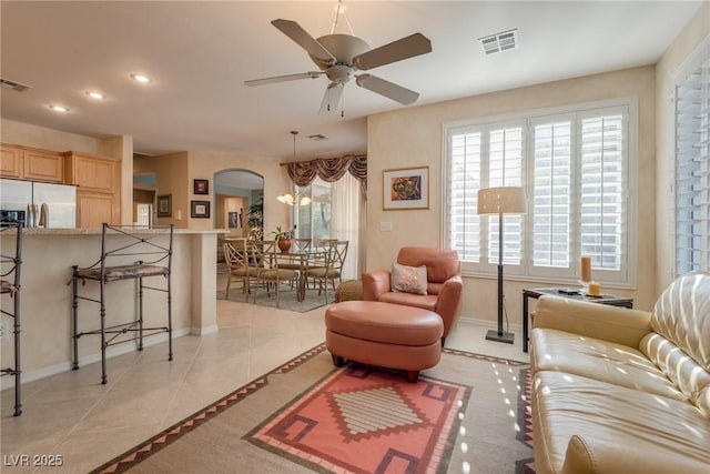 tiled living room featuring ceiling fan