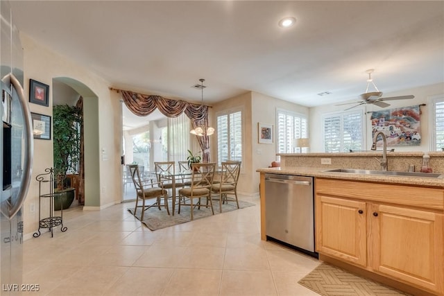 kitchen featuring sink, decorative light fixtures, stainless steel dishwasher, and light tile patterned floors