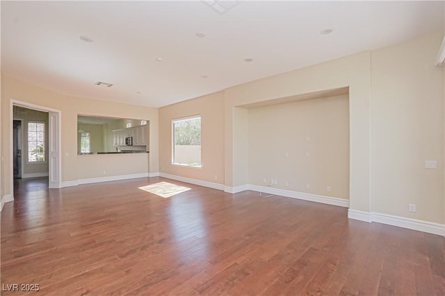 unfurnished living room with dark hardwood / wood-style floors