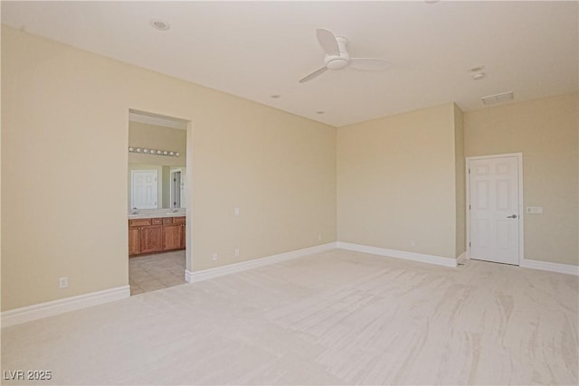 carpeted spare room with ceiling fan