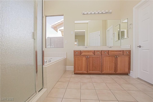bathroom with tile patterned flooring, double vanity, a garden tub, a shower stall, and a sink