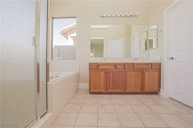 bathroom featuring tile patterned flooring, a stall shower, a bath, and double vanity