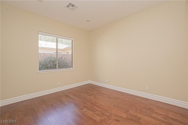 spare room with hardwood / wood-style floors