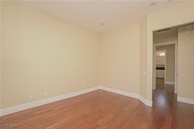 spare room with wood-type flooring