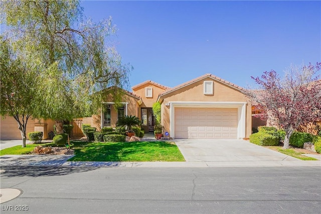 view of front facade featuring a tile roof, an attached garage, driveway, and stucco siding