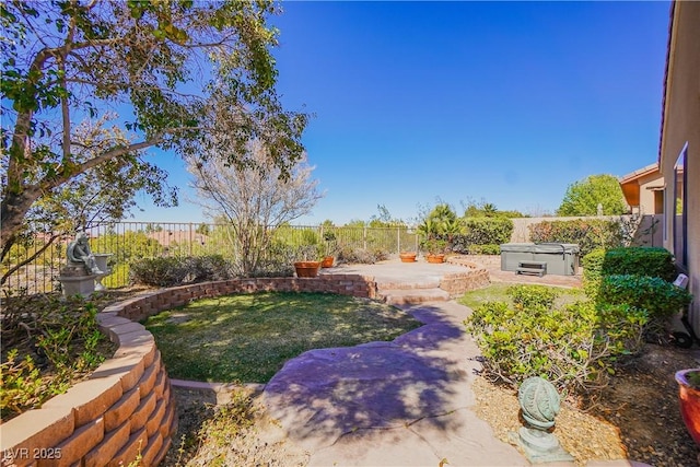 view of yard featuring a patio, a fenced backyard, and a hot tub