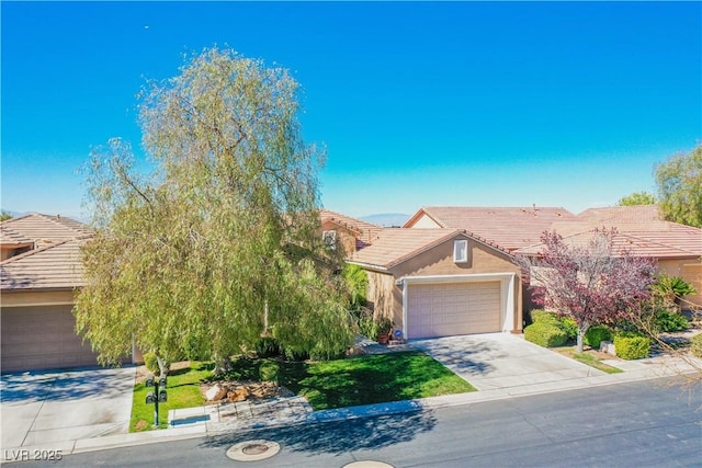 obstructed view of property featuring a garage and a front yard