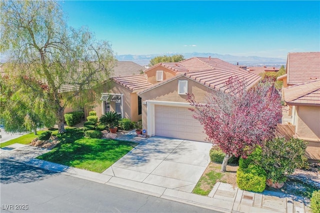 view of front of property featuring a garage, a mountain view, and a front yard