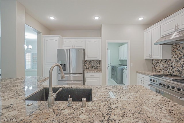 kitchen with light stone counters, tasteful backsplash, stainless steel appliances, and white cabinets