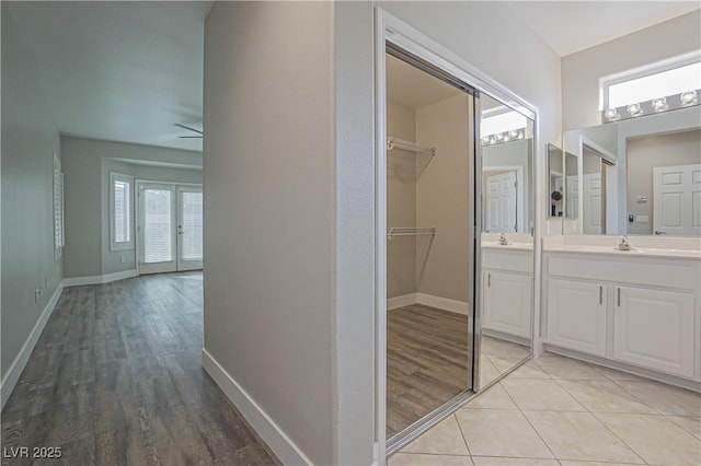 bathroom featuring tile patterned flooring, vanity, a wealth of natural light, and ceiling fan