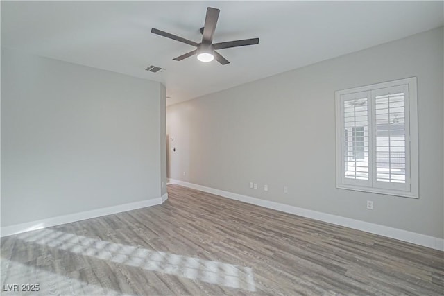 empty room featuring ceiling fan and light hardwood / wood-style flooring