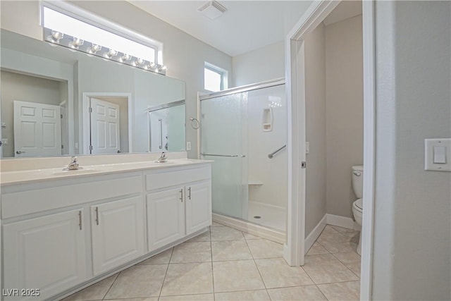 bathroom featuring walk in shower, tile patterned floors, toilet, and vanity