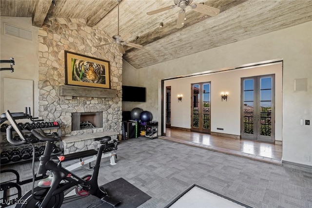 exercise room featuring a fireplace, high vaulted ceiling, ceiling fan, and carpet flooring