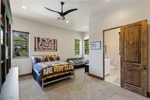 carpeted bedroom with ceiling fan and ensuite bathroom