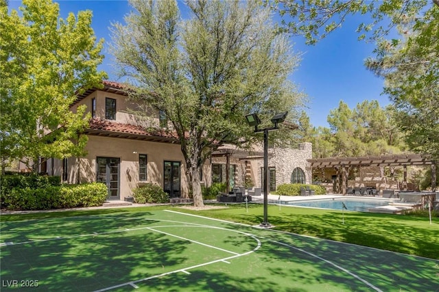 view of basketball court featuring a lawn and a pergola