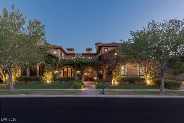 mediterranean / spanish-style house featuring a yard