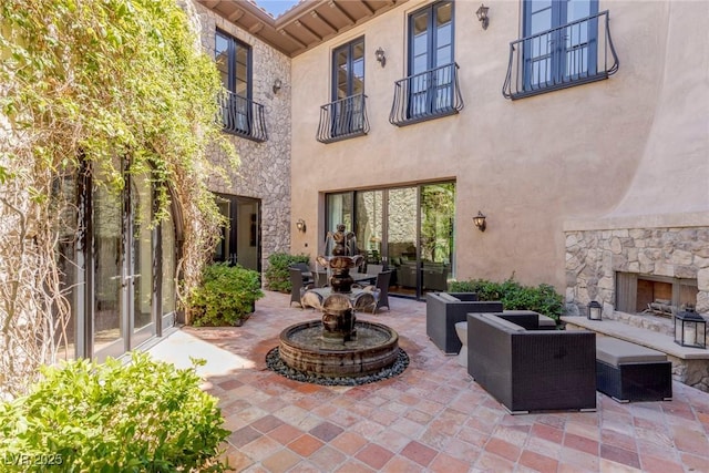 view of patio / terrace with an outdoor stone fireplace