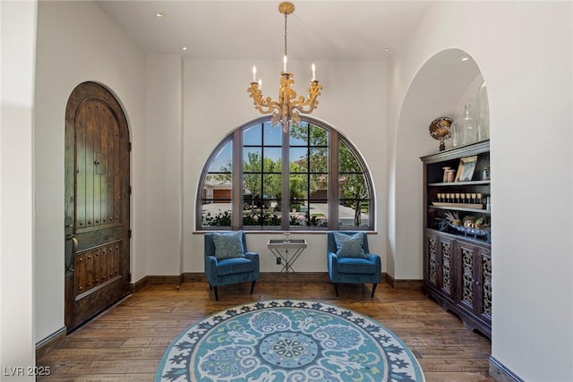 sitting room featuring a notable chandelier and dark hardwood / wood-style flooring