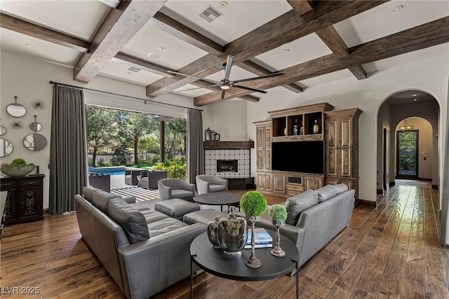 living room featuring dark hardwood / wood-style flooring, a fireplace, and a wealth of natural light