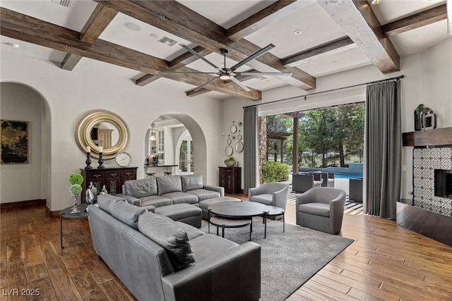 living room with hardwood / wood-style flooring, a fireplace, and ceiling fan