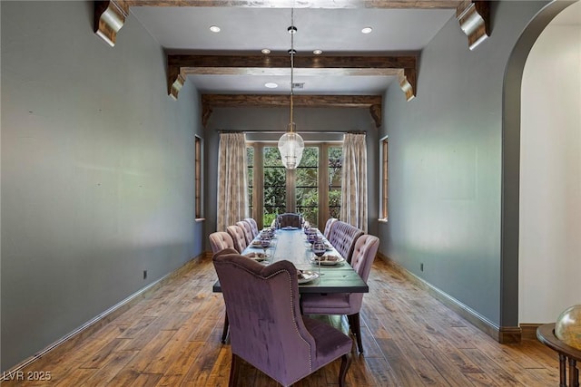 dining area with beamed ceiling and wood-type flooring