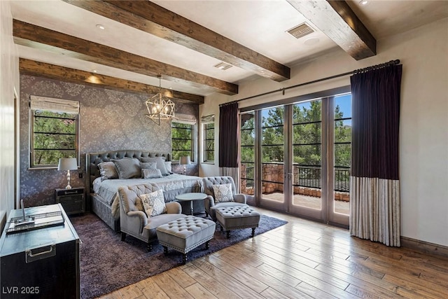 bedroom with hardwood / wood-style flooring, an inviting chandelier, beam ceiling, access to outside, and french doors