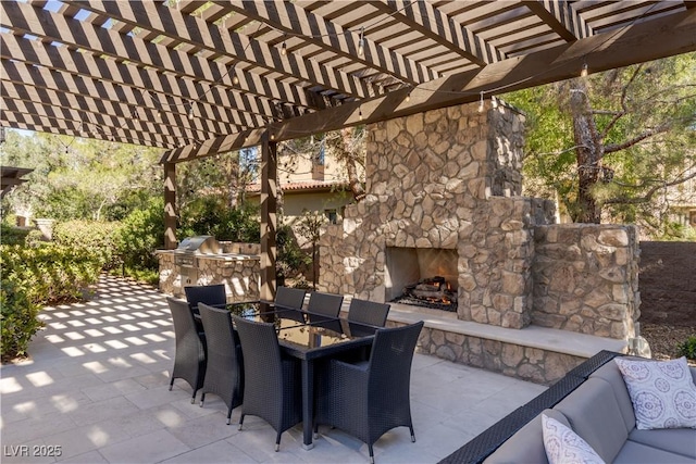 view of patio / terrace featuring area for grilling, an outdoor stone fireplace, and a pergola