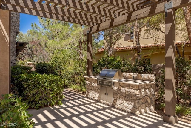 view of patio featuring a pergola, grilling area, and an outdoor kitchen