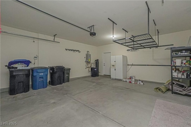 garage featuring a garage door opener, white fridge with ice dispenser, and electric panel