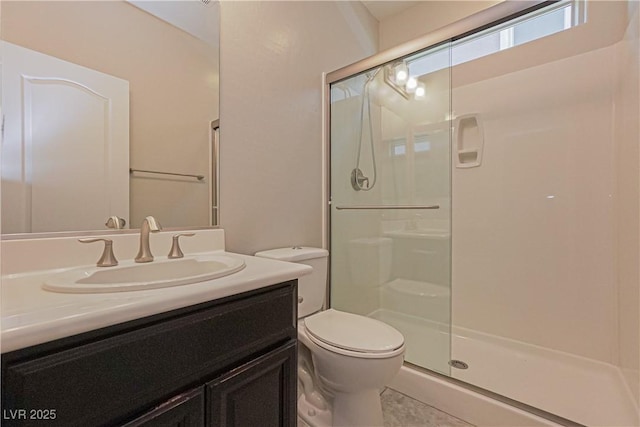 bathroom featuring walk in shower, tile patterned floors, vanity, and toilet