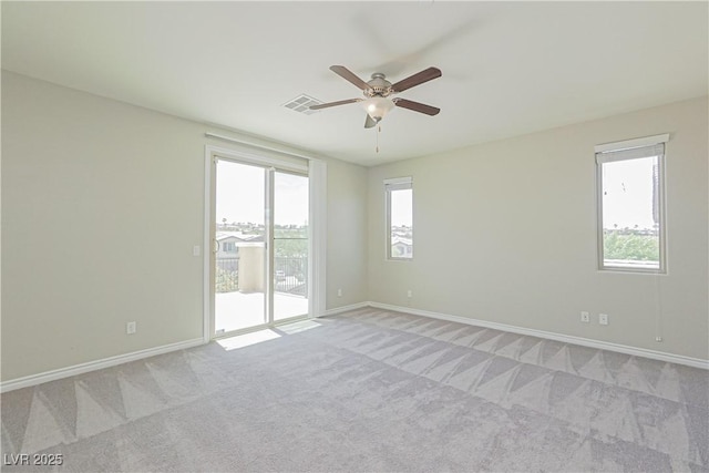 empty room with ceiling fan and light colored carpet