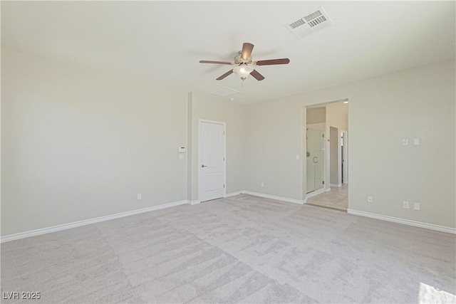 spare room featuring ceiling fan and light carpet