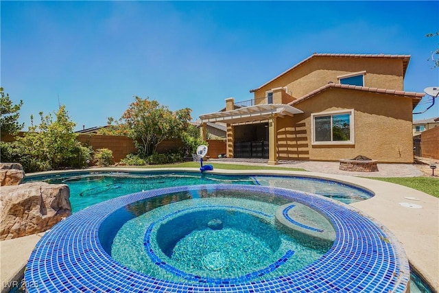 view of pool with an in ground hot tub, a pergola, and a fire pit