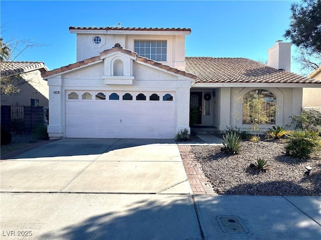 mediterranean / spanish home featuring a garage