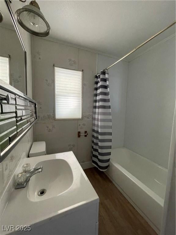 bathroom featuring vanity, wood-type flooring, shower / bath combo, and plenty of natural light